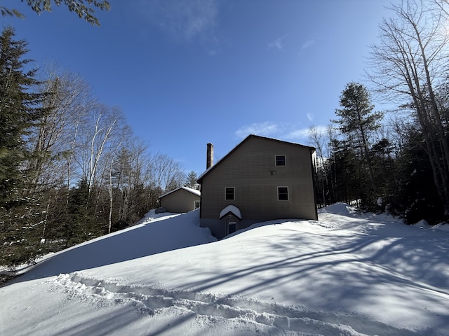 9 Ledge Dr, Greenville, ME 04441 - view of snowy exterior featuring a chimney