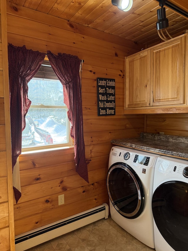 9 Ledge Dr, Greenville, ME 04441 - laundry area featuring wood walls, washer and clothes dryer, a baseboard radiator, and cabinet space