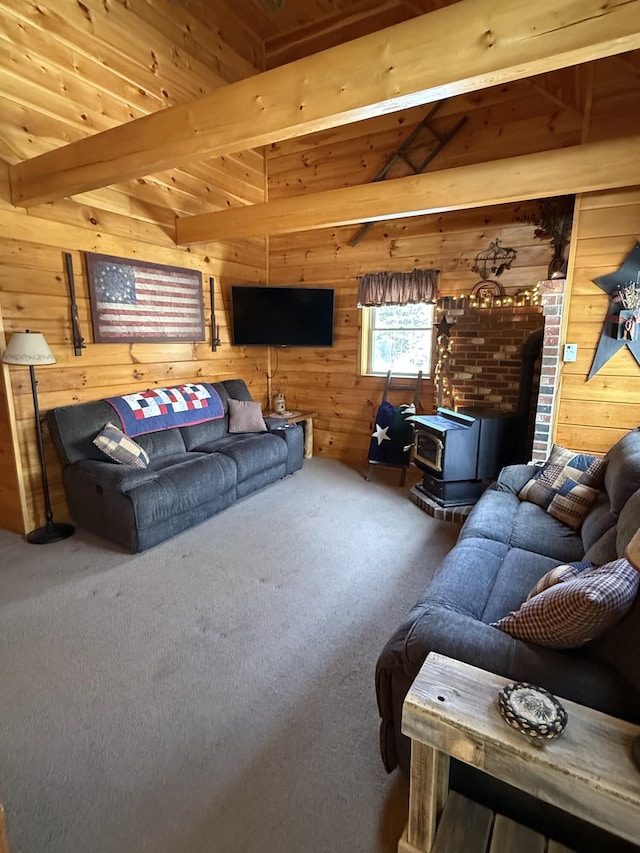 9 Ledge Dr, Greenville, ME 04441 - living room with wooden walls, a wood stove, beam ceiling, wood ceiling, and carpet flooring