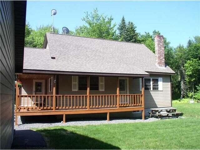 9 Ledge Dr, Greenville, ME 04441 - back of property featuring a lawn, covered porch, and roof with shingles