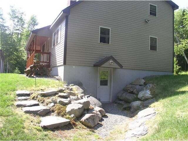 9 Ledge Dr, Greenville, ME 04441 - view of home's exterior featuring a chimney and a yard