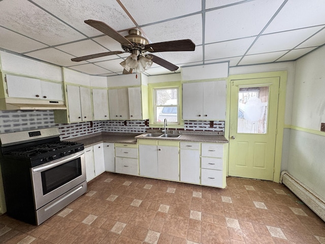 kitchen featuring backsplash, a sink, stainless steel range with gas stovetop, and white cabinets