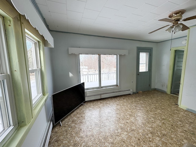 unfurnished room with baseboards, a baseboard heating unit, and ceiling fan