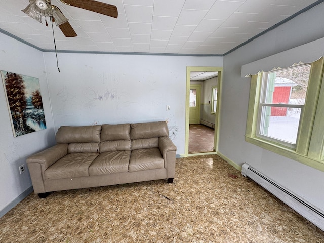 living room featuring ceiling fan, a baseboard radiator, and baseboards