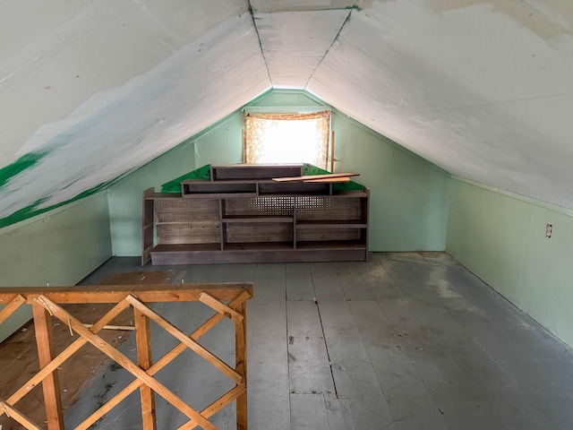 additional living space featuring dark wood-style floors and lofted ceiling