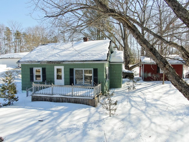 view of front of house featuring covered porch and a chimney