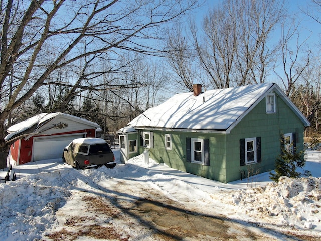 view of front of property with a garage and a chimney