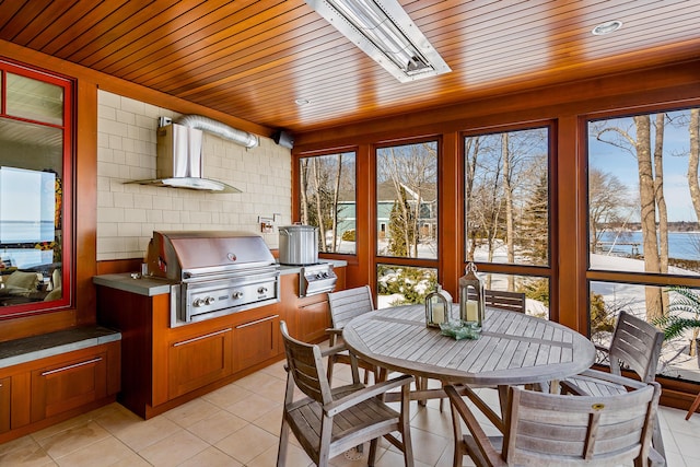 sunroom with wooden ceiling and plenty of natural light