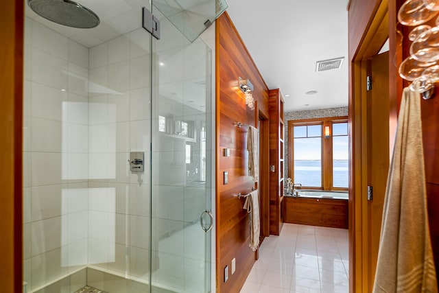 full bathroom with a stall shower, visible vents, and a water view