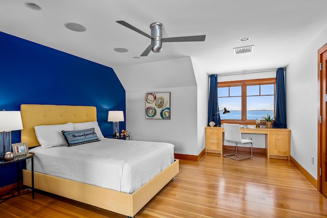 bedroom featuring ceiling fan, wood finished floors, visible vents, and baseboards