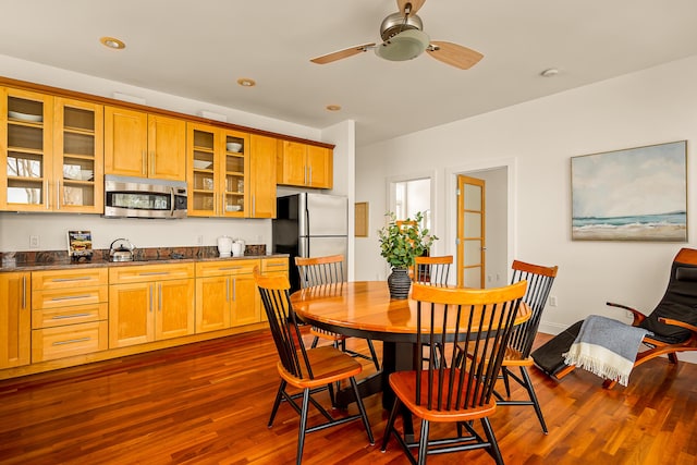 dining area featuring dark wood finished floors, a ceiling fan, and recessed lighting