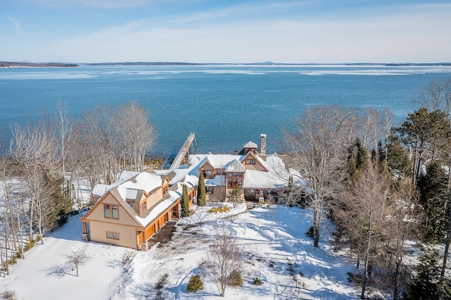 snowy aerial view featuring a water view