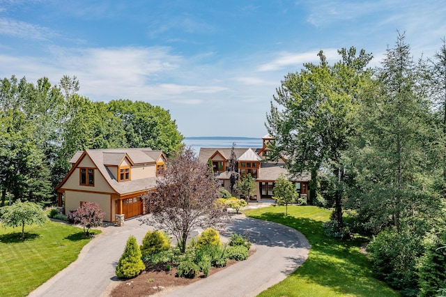 27 Jasmine Way, Belfast, ME 04915 - view of front of home with a garage, curved driveway, and a front lawn