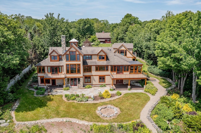 27 Jasmine Way, Belfast, ME 04915 - back of house featuring a patio, a yard, a chimney, a wooden deck, and a balcony
