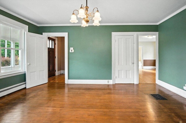 49 Old Village Rd, Winthrop, ME 04364 - spare room featuring a chandelier, wood finished floors, ornamental molding, and baseboard heating