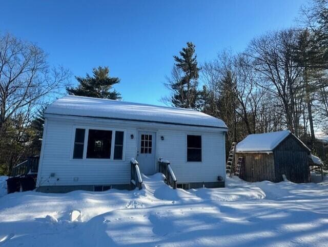 view of front of house with a storage unit and an outdoor structure