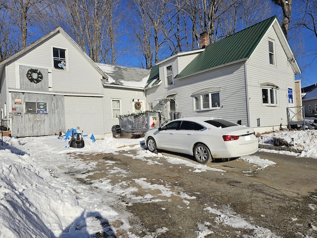 exterior space featuring metal roof and a chimney