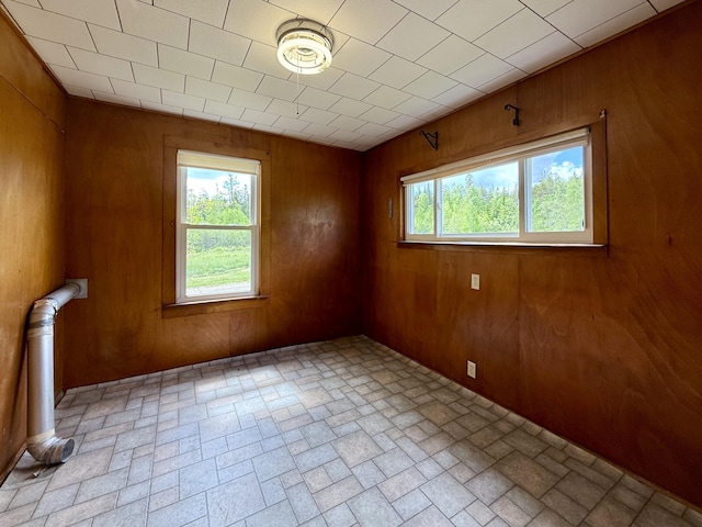 149 Old Eastport Rd, Perry, ME 04667 - empty room with brick patterned flooring, healthy amount of natural light, and wood walls