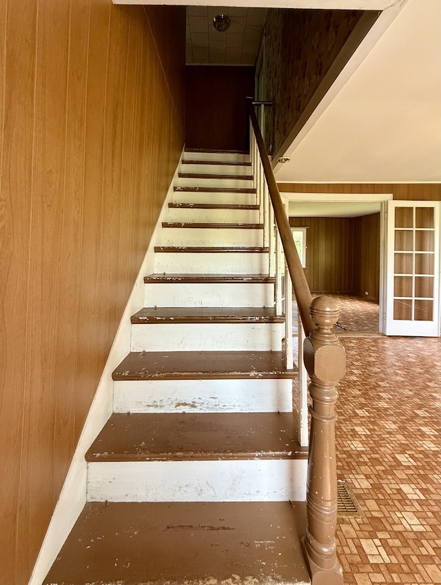 149 Old Eastport Rd, Perry, ME 04667 - staircase with wooden walls and brick patterned flooring