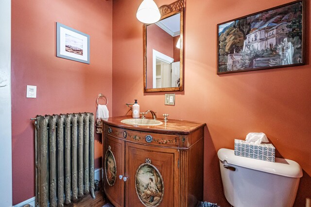 bathroom featuring radiator, toilet, and vanity