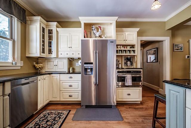 kitchen featuring dark wood finished floors, glass insert cabinets, ornamental molding, stainless steel appliances, and open shelves