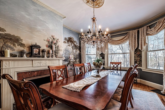 dining room featuring baseboards, a notable chandelier, wood finished floors, and crown molding