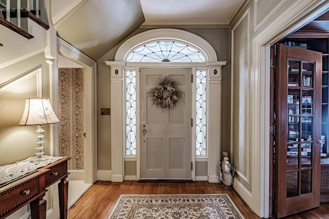 entryway with vaulted ceiling and wood finished floors