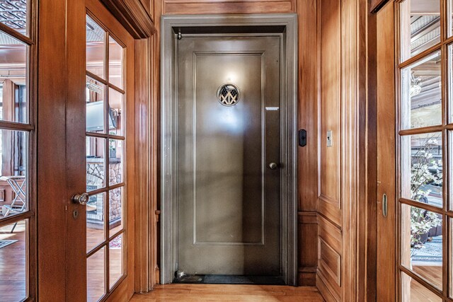 doorway with french doors and light wood-type flooring