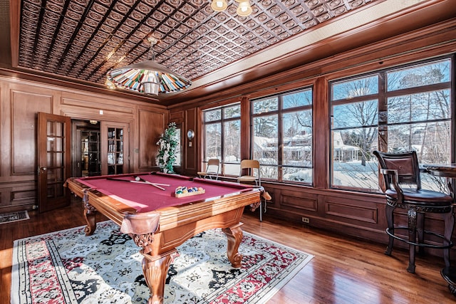 game room featuring an ornate ceiling, billiards, ornamental molding, and wood finished floors