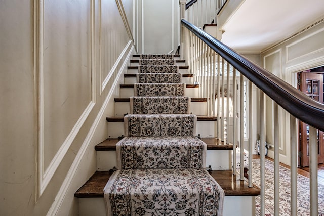 staircase with a decorative wall