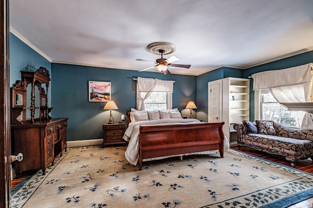 bedroom featuring a ceiling fan, crown molding, and baseboards