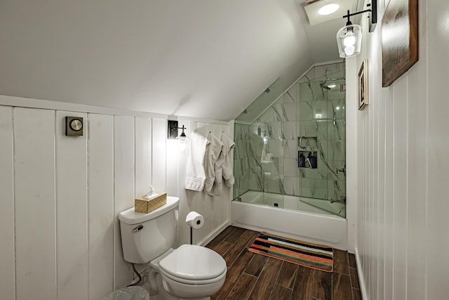 bathroom featuring wood tiled floor, tub / shower combination, vaulted ceiling, and toilet