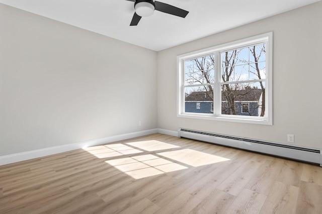 unfurnished room with a ceiling fan, wood finished floors, baseboards, and baseboard heating