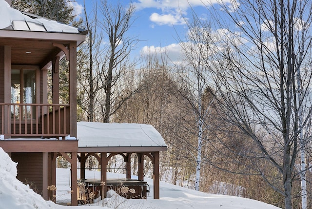 yard covered in snow with a hot tub