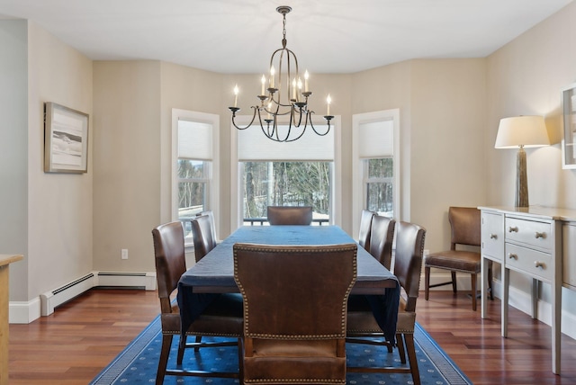 dining space with dark wood-style flooring, baseboard heating, and a notable chandelier