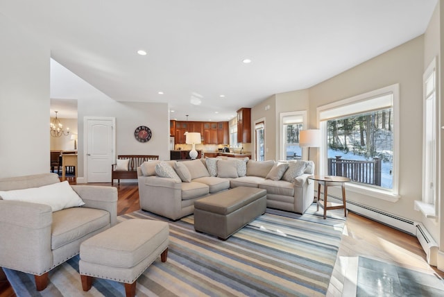 living room featuring a chandelier, light wood-style flooring, and recessed lighting