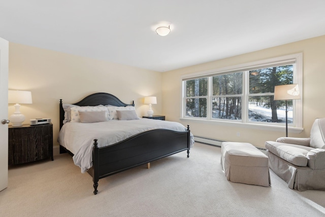 bedroom with a baseboard heating unit and light carpet