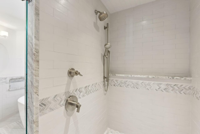 full bath featuring a tile shower and tile walls