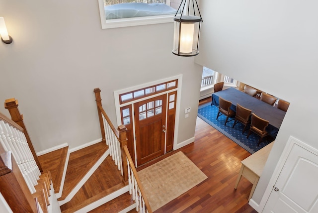 entryway with baseboards and wood finished floors