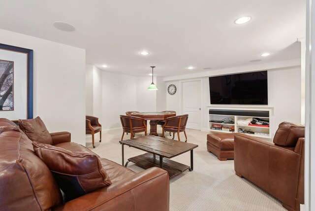 living area featuring light carpet and recessed lighting