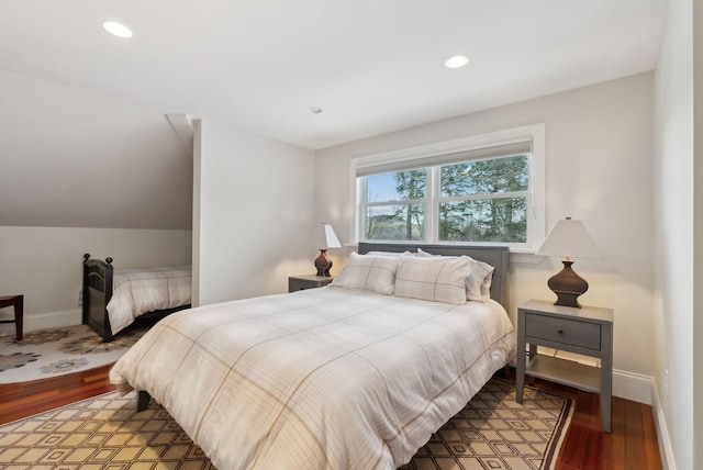 bedroom with lofted ceiling, recessed lighting, baseboards, and wood finished floors