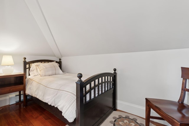 bedroom featuring lofted ceiling, dark wood-style floors, and baseboards