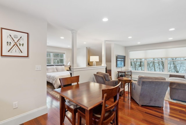 dining space featuring recessed lighting, wood finished floors, decorative columns, and baseboards