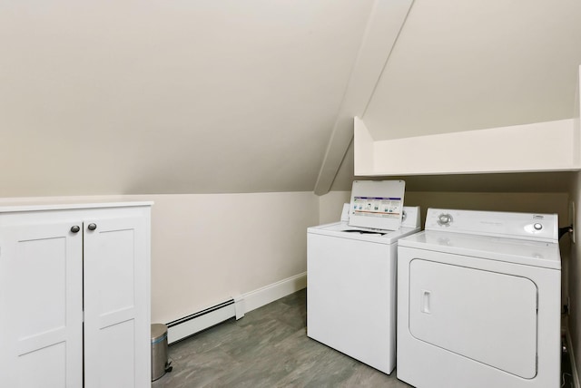 clothes washing area featuring washing machine and dryer, wood finished floors, baseboards, baseboard heating, and cabinet space