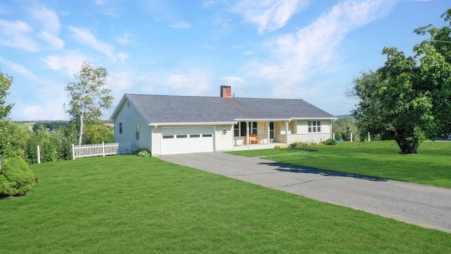 single story home featuring a chimney, an attached garage, fence, driveway, and a front lawn