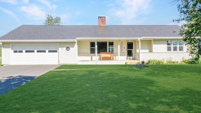 single story home with a chimney, a porch, a garage, driveway, and a front lawn