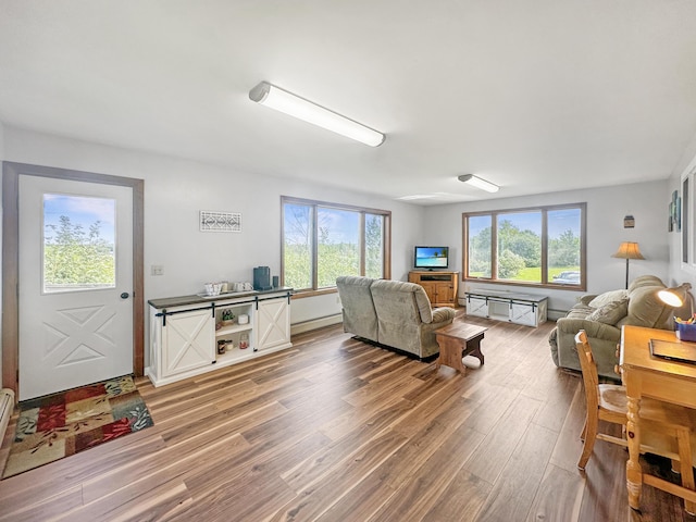 living room featuring baseboard heating and wood finished floors