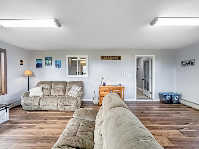 living room featuring baseboard heating, wood finished floors, and baseboards