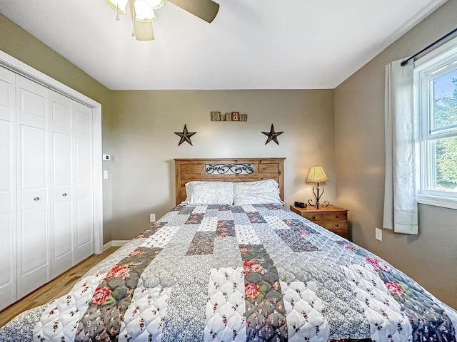 bedroom with baseboards, a closet, a ceiling fan, and wood finished floors