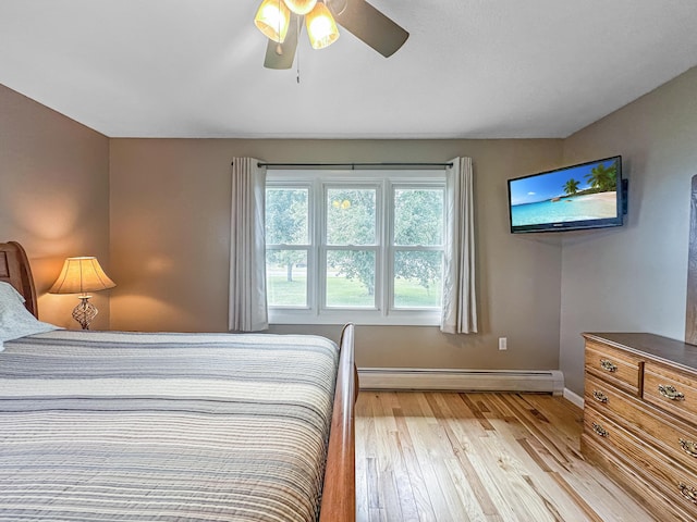 bedroom featuring light wood-style floors, baseboards, ceiling fan, and baseboard heating